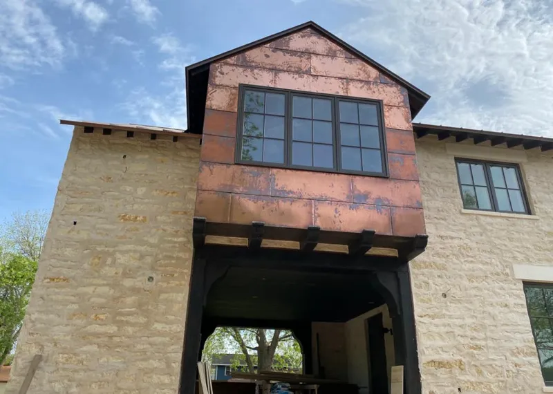 Copper metal panel facade on a stone building for Roof Repair in Peoria